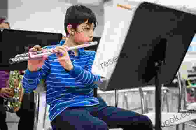 A Young Student Playing The Flute Attentively, Surrounded By Musical Instruments And Sheet Music. Student Instrumental Course Flute Student: Level III