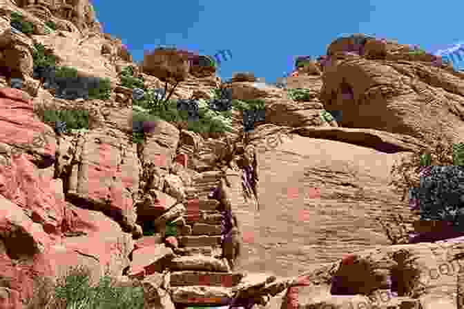 Hikers Exploring The Rugged Trails Of Red Rock Canyon National Conservation Area, Surrounded By Towering Sandstone Formations. Red Rock Canyon National Conservation Area: A Casual Hiker S Guide To Nature And Ancient Artifacts